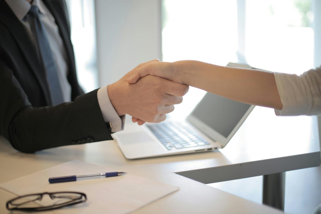 Professional handshake during a job interview, representing companies hiring veterans in the UAE, US, and UK